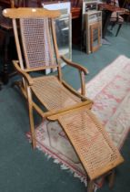 An Edwardian satin wood folding bergere chair