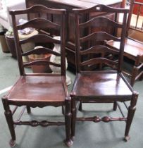 A pair of early 20th century ladderback solid seated chairs