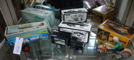 Three tin plate toys, includes a clockwork Zeppelin, a clockwork motorcycle and a model of a 1924 He