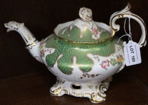 A 19th century china teapot, gilded green with floral decoration