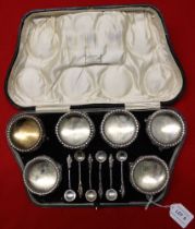 A Victorian cased set of six silver salts, embossed floral decoration, together with six apostle ter