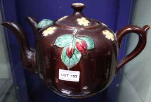 A late Victorian treacle glazed terracotta double pouring teapot, applied and painted floral decorat