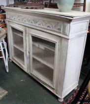 A white painted sideboard with mesh doors, in an overall distressed condition