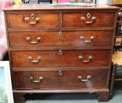 A 19th century mahogany chest of two short over three long drawers with brass handles, on bracket fe
