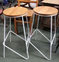 Two white metal framed stacking wooden topped bar stools