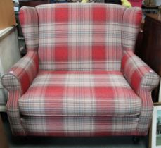 A modern small size two seater wing back sofa in red check upholstery