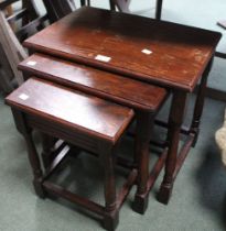 A nest of three dark wood tables