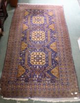 A large floor rug, blue & brown based geometric pattern, approx 220cm x 110cm