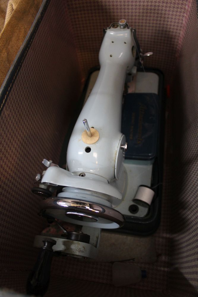 A Jones hand operated sewing machine in blue carry case