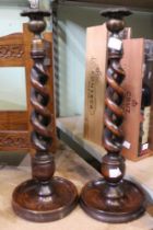 A pair of oak 19th century twisted stem & brass topped candlesticks