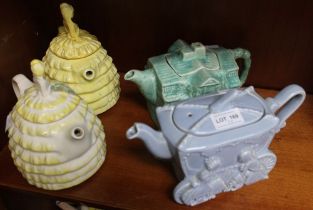 Two Crinoline lady pottery teapots, together with a Cinderella teapot, glazed blue and a green cotta