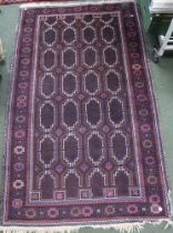 A large floor rug, plum ground geometric pattern, 200cm x 160cm