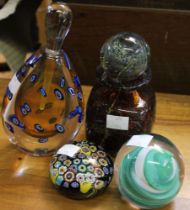 A Murano glass scent bottle with another bottle with stopper and two glass paper weights