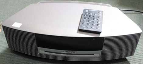 A Bose CD player with remote control