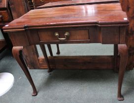 A Georgian mahogany flip top tea table with single drawer & canted corners