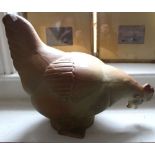 A ceramic figure of a pecking Chicken