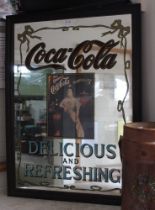 A decorative "Coca-Cola" mirror, 84cm x 59cm, in a moulded stained wood frame