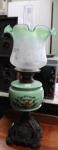 A Victorian metal based oil lamp with porcelain reservoir and glass shade and funnel