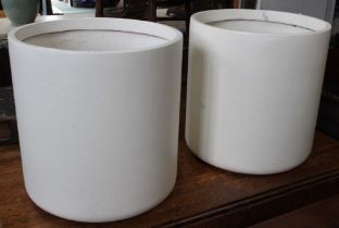 A pair of white plastic circular tubs