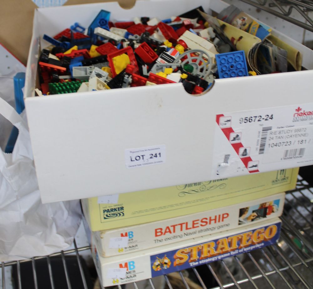 A box containing a wide selection of Lego, together with three boxed board games