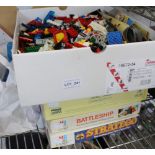 A box containing a wide selection of Lego, together with three boxed board games
