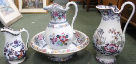 A late Victorian pottery water jug and bowl, hand coloured floral decoration, together with two othe