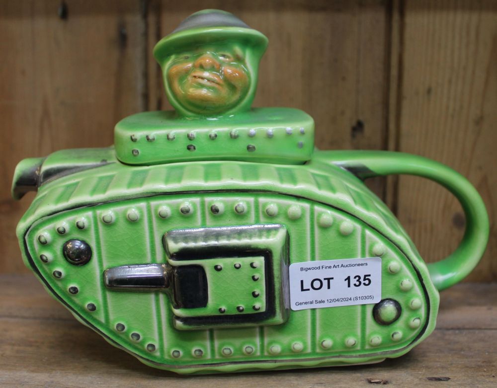 A ceramic teapot modelled as a First World War tank, the lid knop in the form of an "Old Bill" chara