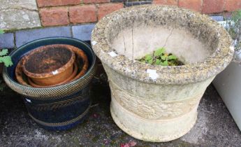 A cast garden planter with floral decorated band