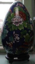 A large Chinese cloisonne enamel ovoid form ornament, overall decorated in polychrome with exotic bi