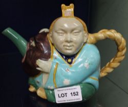 A MInton majolica ceramic "Chinaman" teapot, modelled as a seated figure, his hair plait as the hand