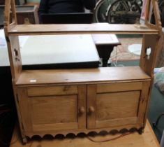 A rustic pine wall hanging cupboard with two doors and open shelves