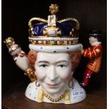 A "Totally Teapots" ceramic teapot, featuring Queen Victoria on one side and Queen Elizabeth ll on t