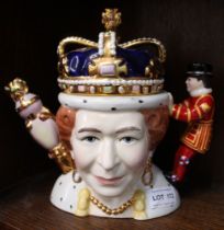 A "Totally Teapots" ceramic teapot, featuring Queen Victoria on one side and Queen Elizabeth ll on t