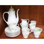 A Susie Cooper coffee service, almond green floral design, gilded, comprising coffee pot, sugar bowl