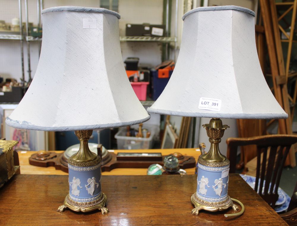 A pair of Wedgwood and decorative brass table lamps with blue shades