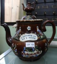 A late Victorian "Bargee" teapot, treacle glazed with applied decoration including the panel inscrib