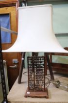 A hardwood Oriental Abacus style lamp base with shade