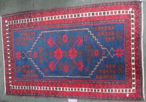 A small hearth rug, blue & red ground geometric pattern, 135cm x 84cm