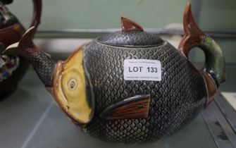 A late 19th century teapot modelled as a fish, consuming a smaller fish