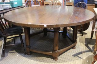 A large 20th century oak round table on a substantial hexagonal base 167cm diam