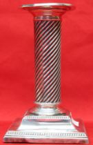 A column design silver candlestick, raised on square stepped base, marks rubbed, 13.5cm high