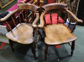 A pair of early 19th century smokers bow armchairs stamped Dowler, Warwickshire cabinet makers