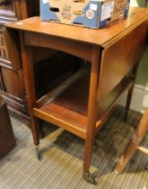 A teak mid-century twin flap two-tier tea trolley