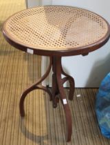 A small bentwood occasional table with bergere top