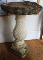 a cast concrete garden bird bath