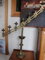 A pair of brass ecclesiastical candelabras with mechanical adjustment in the gothic style