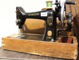 A vintage Singer sewing machine in wooden carry case