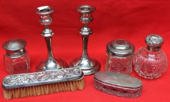 A collection of hallmarked silver items, includes a pair of silver candlesticks, a cut glass grenade