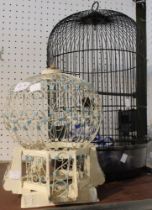 Two bird cages, one metal the other a wooden ornamental version