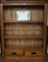 a modern beech three shelf bookcase with 2 drawers below